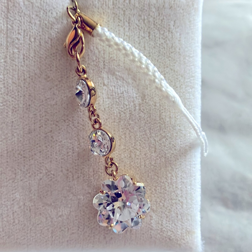 This triple A quality cubic zirconia and gold zipper pull or purse jewelry